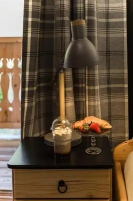 a table with a lamp and a plate of food on it at Góralska Willa in Nowy Targ