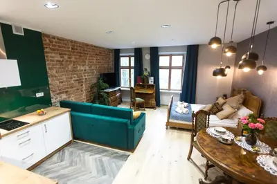 a living room with a couch and a table at Luxury in the Heart of the Old Town in Kraków