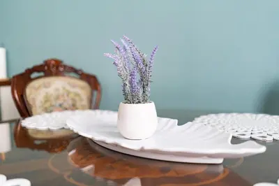 a table with a white vase with purple flowers in it at Luxury in the Heart of the Old Town in Kraków