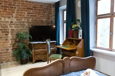 a living room with a desk and a television at Luxury in the Heart of the Old Town in Kraków