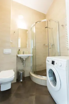a washing machine in a bathroom with a shower at Luxury in the Heart of the Old Town in Kraków