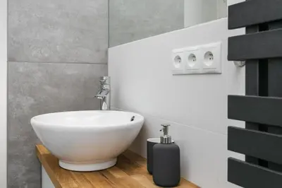 a bathroom with a white sink in a room at City of the Kings Arianska Garden in Kraków