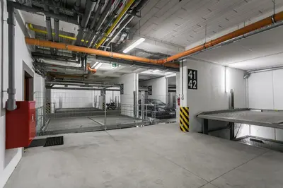 an empty parking garage with a lot of pipes at City of the Kings Arianska Garden in Kraków