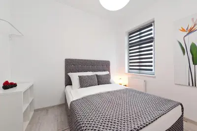a bedroom with a bed and a window at Apartament Solny Centrum Wieliczka 11 in Wieliczka