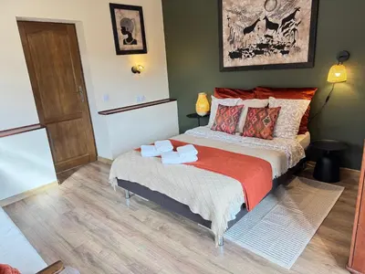 a bedroom with a bed with two towels on it at Przystanek Rabka - Apartamenty w centrum in Rabka