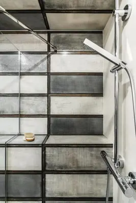 a metal staircase in a bathroom with a sink at Academia Apartments in Kraków