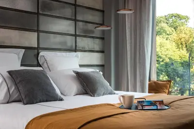 a bedroom with a large bed and a window at Academia Apartments in Kraków