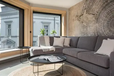 a living room with a couch and a table at Academia Apartments in Kraków