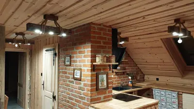 a kitchen with a brick wall and a sink at Mountain cabin in Pcim