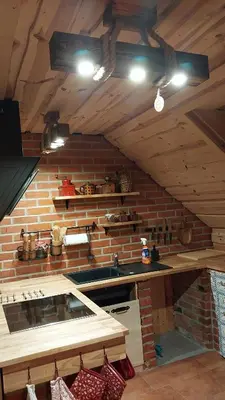 a kitchen with a sink and a brick wall at Mountain cabin in Pcim