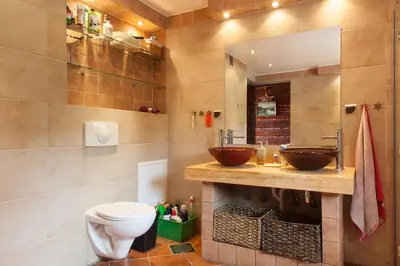 a bathroom with two sinks and a toilet at Mountain cabin in Pcim