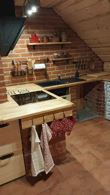 a kitchen with a stove and a brick wall at Mountain cabin in Pcim