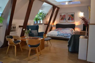 a bedroom with a bed and a table and chairs at Akwarela I in Kraków