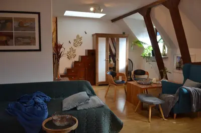 a living room with a green couch and chairs at Akwarela I in Kraków