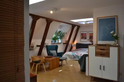 a bedroom with a bed and a table and chairs at Akwarela I in Kraków