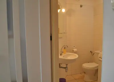 a bathroom with a toilet and a sink at Akwarela I in Kraków