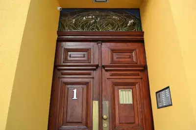 a wooden door with a number above it at Akwarela I in Kraków