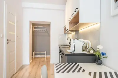 a kitchen with white cabinets and a sink at Modern Apartment close to the center by Krakow Home in Kraków