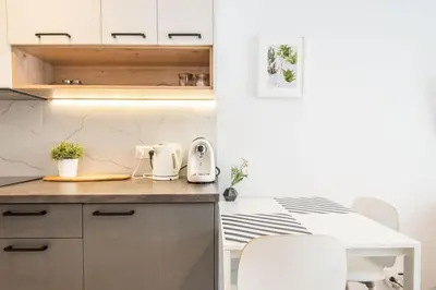 a kitchen with a counter top and a table at Modern Apartment close to the center by Krakow Home in Kraków
