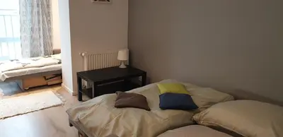 a room with a bed with a pillow on it at Modern Apartment close to the center by Krakow Home in Kraków