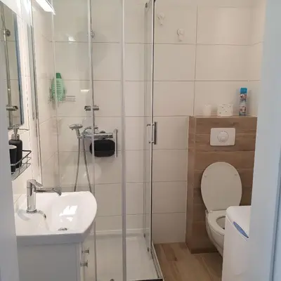 a bathroom with a shower and a toilet and a sink at Modern Apartment close to the center by Krakow Home in Kraków