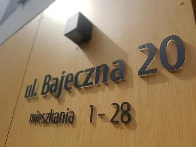 a sign on the side of a building at Apartments Olit Bajeczna in Kraków