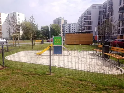 a batting cage with a playground in a city at Apartments Olit Bajeczna in Kraków