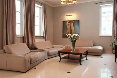 a living room with couches and a table with flowers at Villa Julia in Kraków