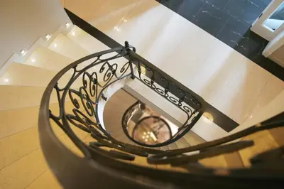 a spiral staircase in a building with a clock at Villa Julia in Kraków