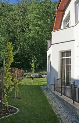 a garden in front of a house with a lawn at Villa Julia in Kraków