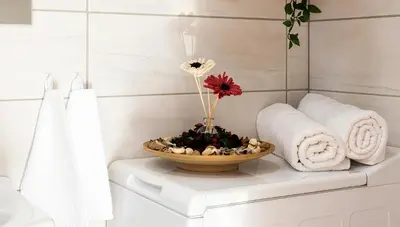 a bathroom with a bowl with a flower in it at Cracow Best Location Apartment with Garden by Cozyplace in Kraków