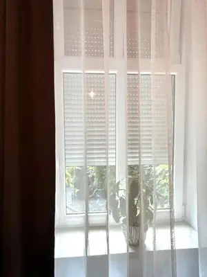 a window with a plant in a vase at Cracow Best Location Apartment with Garden by Cozyplace in Kraków