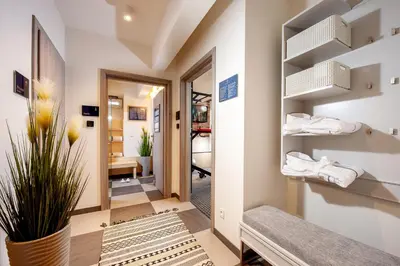 a hotel room with a bed and flowers in it at Amber Design Residence in Kraków