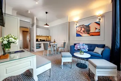 a living room with a blue couch and a table at Amber Design Residence in Kraków
