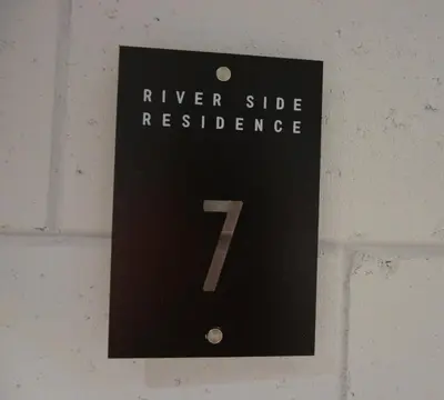 a sign on a wall that reads river side residence at River Side Residence nr 1m7 in Oświęcim