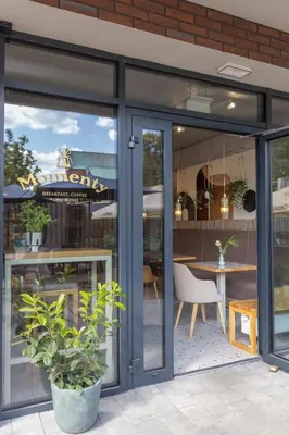 a restaurant with sliding glass doors and a table at River Side Residence nr 1m7 in Oświęcim