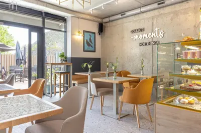 a restaurant with tables and chairs and a sign on the wall at River Side Residence nr 1m7 in Oświęcim