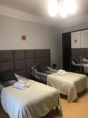 a hotel room with two beds and a mirror at Apartment Family Krakow in Kraków