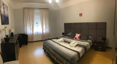 a bedroom with a large bed with two pillows on it at Apartment Family Krakow in Kraków