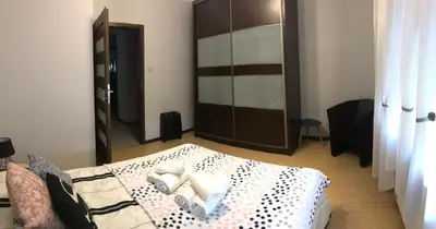 a bedroom with a bed and a large mirror at Apartment Family Krakow in Kraków