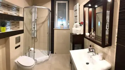 a bathroom with a shower and a toilet and a sink at Apartment Family Krakow in Kraków