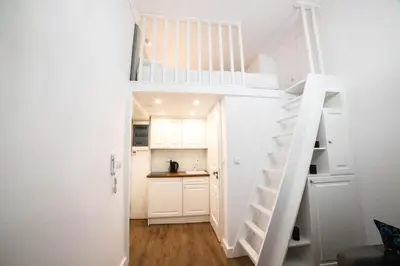 a white staircase in a small room with a kitchen at Saint Philip in Kraków
