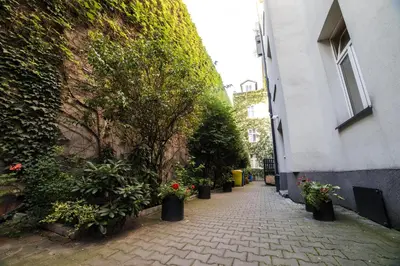 a sidewalk with plants and flowers next to a building at Saint Philip in Kraków