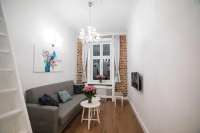 a living room with a couch and a table at Saint Philip in Kraków