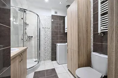 a bathroom with a toilet and a sink and a shower at Urban Nest Apartments Józefitów 5 in Kraków