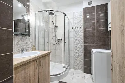 a bathroom with a shower and a sink at Urban Nest Apartments Józefitów 5 in Kraków