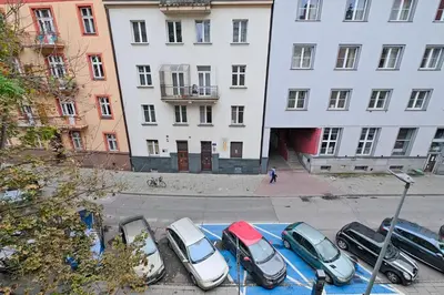 a row of cars parked in a parking lot in front of buildings at Urban Nest Apartments Józefitów 5 in Kraków