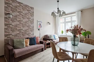 a living room with a couch and a table at Urban Nest Apartments Józefitów 5 in Kraków