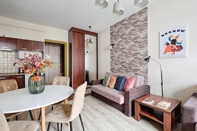 a living room with a table and a couch at Urban Nest Apartments Józefitów 5 in Kraków