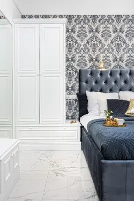 a bedroom with a bed with a tufted headboard at Golden Fish - New Apartment - Old Town in Kraków